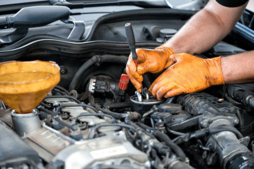 mechanic performing car engine maintenance